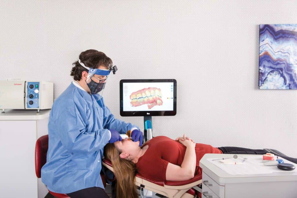 Dr Jonathan Nicozisis scanning a patient's teeth