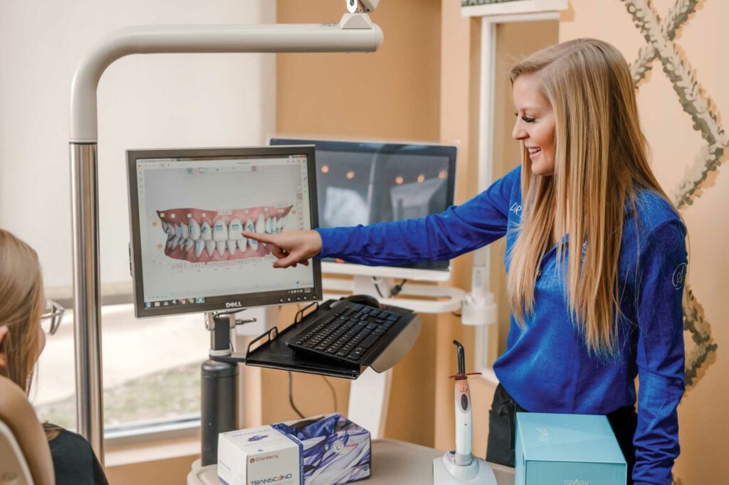 Dr Alyssa Emory Carter treating a patient with aligners