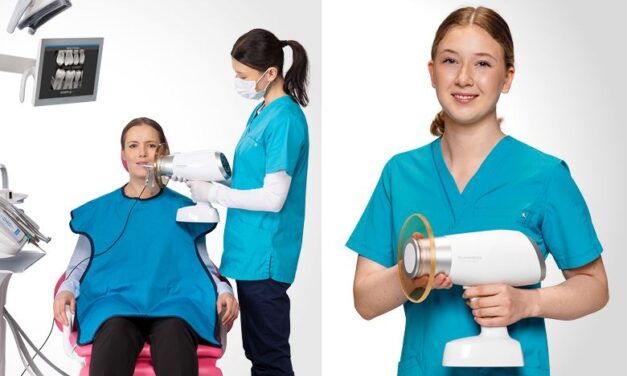 Planmeca ProX Go handheld x-ray show in the technician's hand being used on a patient sitting in a dental exam chair.