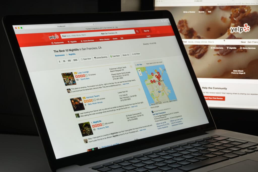 Yelp search results page on a laptop showing local business reviews