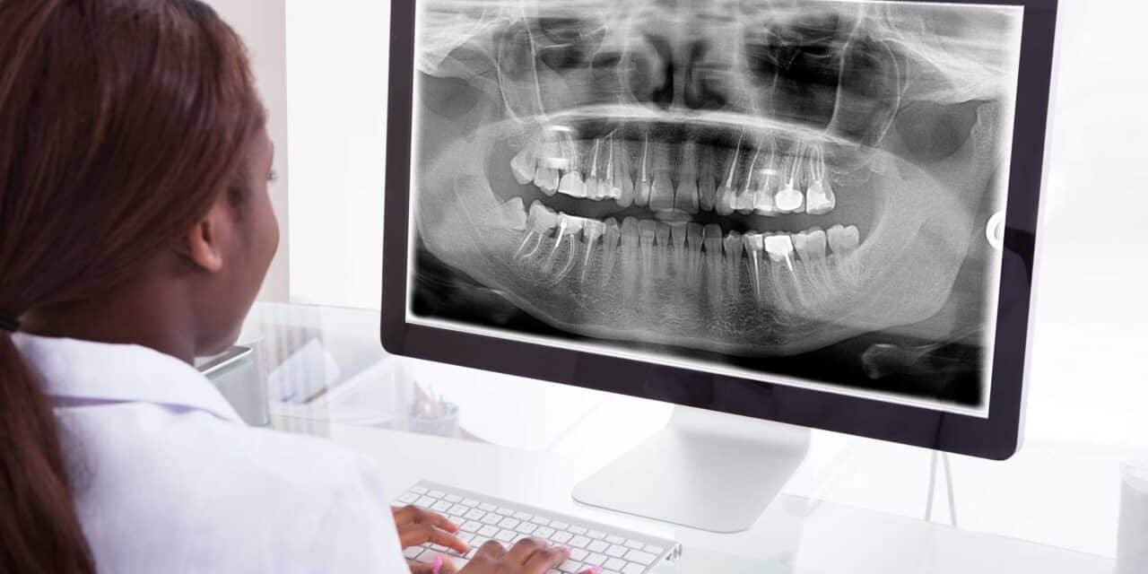 dental tech looking at dental radiograph