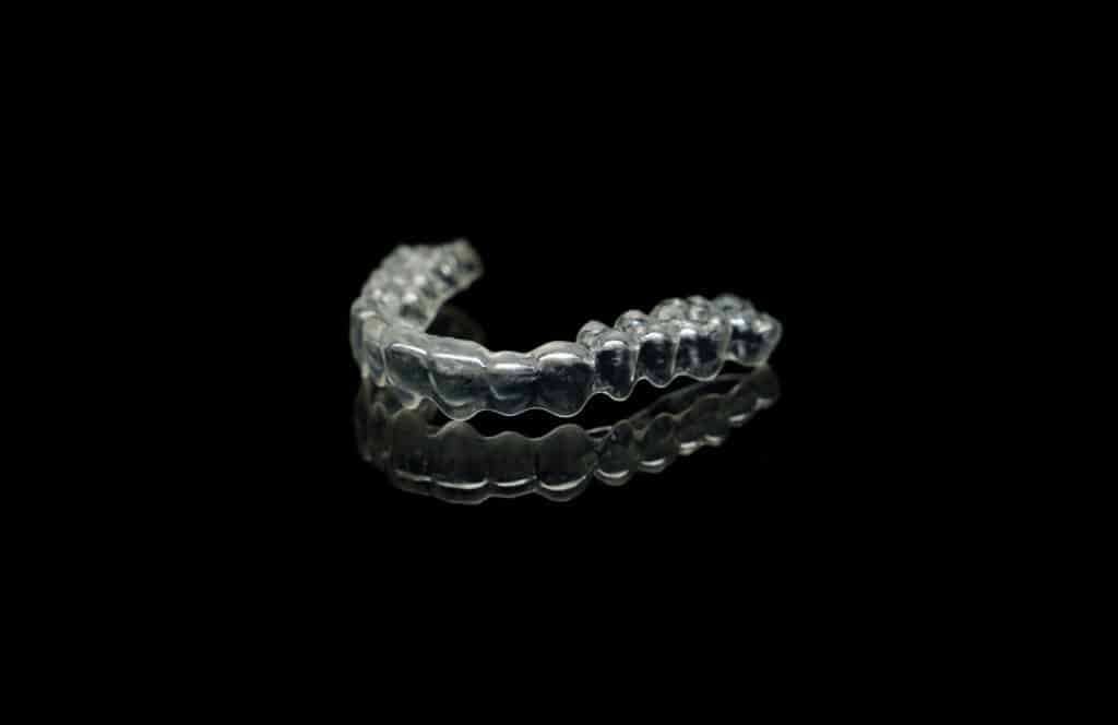 A clear retainer on a black background