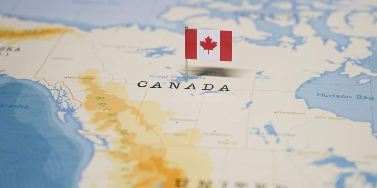Canadian flag pinned to map of Canada